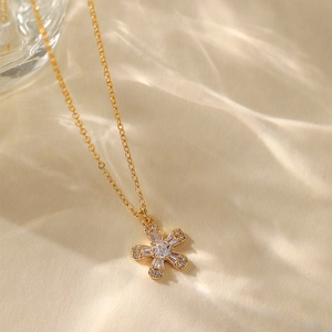 Luxurious 18K gold plated necklace with zircon star pendant on a textured warm background