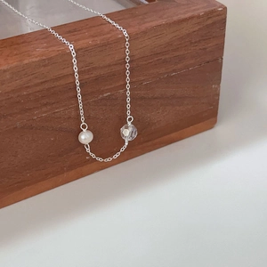 Minimalist 925 sterling silver necklace with white pearl and faceted bead on wood box