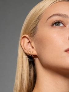 Detail view of 6mm to 9mm gold s925 silver hoop earrings on ear for size comparison