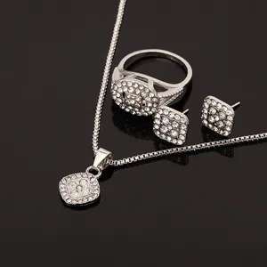 Luxe silver alloy geometric jewelry set with sparkling rhinestones on black mirror surface