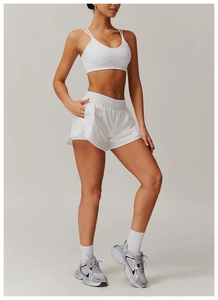White quick-dry yoga set showing cross-back sports bra and shorts with side pocket