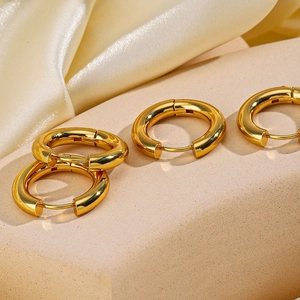 Minimalist chunky 18K gold plated stainless steel hoop earrings on silk background