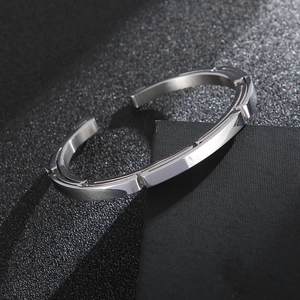 Polished silver stainless steel open bangle with a geometric segmented design for couples