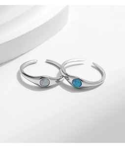Macro detail of S925 sterling silver rings with white and blue opal in adjustable open design