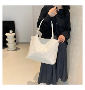 Detailed view of woven texture and spacious interior of the creamy white tote bag