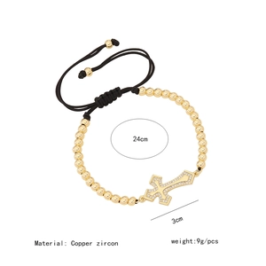 Detail of 18K gold cross bracelet with cubic zirconia and black cord specifications