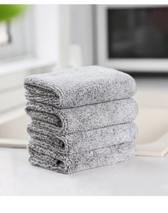 Macro shot of five stacked grey microfiber dishcloths with soft bamboo charcoal texture