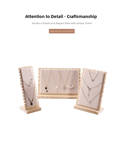 Macro detail of wooden necklace display stands with beige velvet slots for jewelry