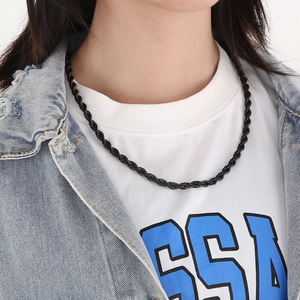 Close-up of black braided twist rope chain necklace worn by a model for detail