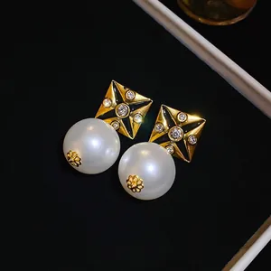Vintage square stud earrings with black enamel cross, sparkling rhinestones, and white pearls