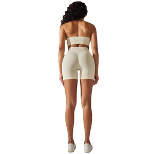 Women's seamless ribbed yoga set in beige featuring crop top and high waist lifting shorts