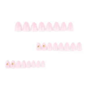 Short almond press-on nails in light pink with 3D embossed flower patterns and gold beads