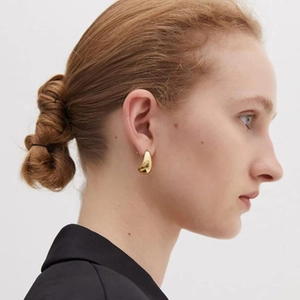 Polished 18k gold teardrop stud earrings for women featuring a minimalist water drop design