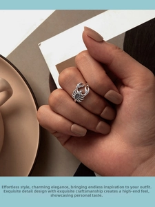 Macro detail of a vintage silver crab ring featuring a black teardrop gemstone on the band