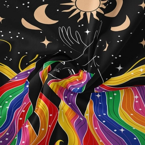 Detail of artistic wall tapestry fabric showing sun, moon, stars and colorful wavy lines