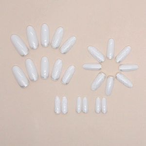 Medium oval press-on nails with white relief knit patterns and silver glitter accents