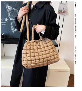 Close-up of khaki quilted puffer tote bag featuring premium checkered texture and soft handle
