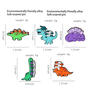 Size chart showing five cartoon dinosaur enamel pins with academic hat and book details