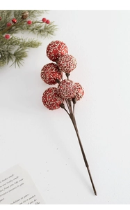 Close-up of red Christmas berry branch with glitter sequins for festive table decoration
