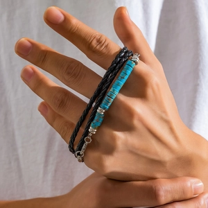 Detail of double-layer men's bracelet with black braided leather and blue turquoise beads