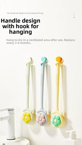 Three long-handled bath brushes in macaron colors hanging on a white wall