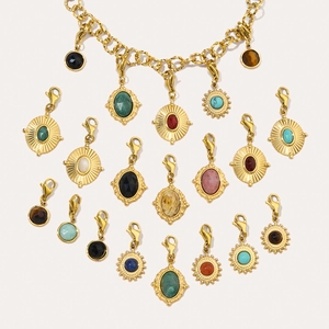 Macro shot of assorted colorful natural stone sun pendants with gold stainless steel clasps