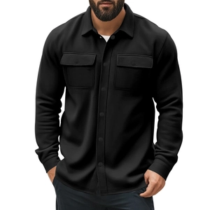 Detail of solid black long sleeve work jacket with dual chest pockets and lapel collar