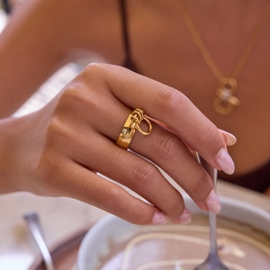 Minimalist gold titanium steel ring featuring interlocking triple knot design for women