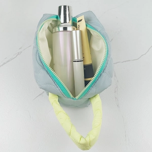 Inside view of a large light blue quilted makeup bag showing spacious internal capacity