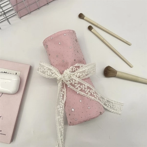 Pink star-pattern makeup brush roll bag with delicate white floral lace bow detail