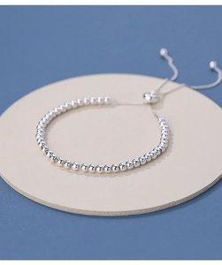 Detail of adjustable S925 silver beaded bracelet with sliding clasp on display board