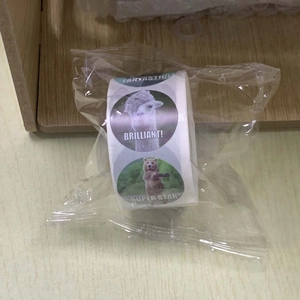 Close-up of animal sticker roll with realistic llama and bear patterns in plastic wrap
