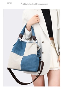Detail of color-block canvas tote bag with brown leather straps and metal rings