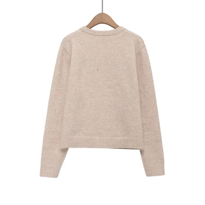 Back view of classic crewneck knit sweater with ribbed cuffs in soft oatmeal shade