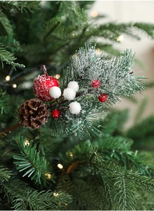 Close-up of Christmas pick with pine cones, red apples, berries and snow-dusted pine needles