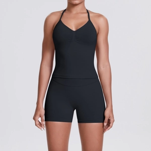 Detail of high-stretch black halter neck sports bra and high-waist yoga shorts set
