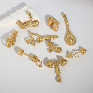 Golden sports charms set featuring dumbbells and gym gear on a clean white surface