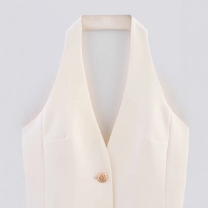 Minimalist cream halter vest top featuring a deep V-neck and gold button detail
