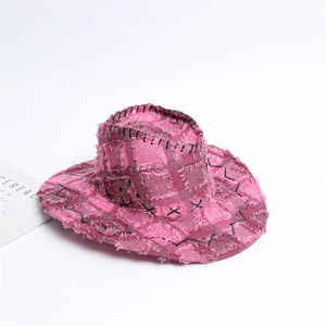 Pink western cowboy hat with distressed edges and black stitching on white background