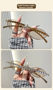 Detail of vintage oval metal sunglasses with heart-shaped crystal embellishments and tea lenses