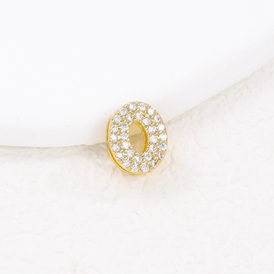 Close-up of golden bubble letter O charm with sparkling cubic zirconia pavé stones