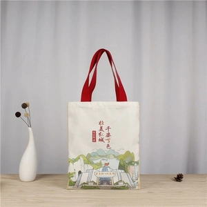 Detailed close-up of Van Gogh style landscape print on canvas tote bag with red handles
