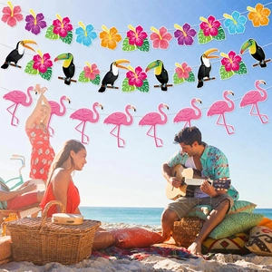Tropical Hawaiian party banners featuring flamingos and toucans at a beach picnic