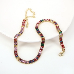 Macro detail of rainbow baguette-cut crystals on gold-plated adjustable necklace