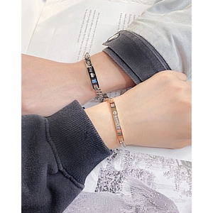 Matching couple bracelets in rose gold and black titanium steel with Her King and His Queen engravings