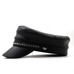 Detailed close-up of a black faux leather baker boy hat with silver rivet chain detail