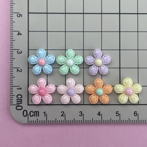 Detailed size comparison of mini resin flower charms next to a ruler for DIY crafts