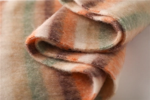 Close-up of thick striped faux cashmere scarf showing plush texture and fringe detail
