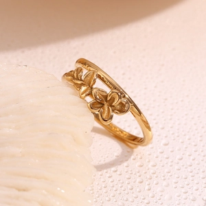 Macro shot of gold plated double layer ring featuring two delicate floral motifs