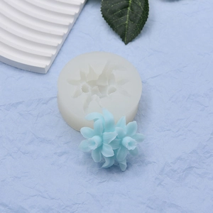 Detailed view of translucent flower silicone mold with finished blue fondant narcissus